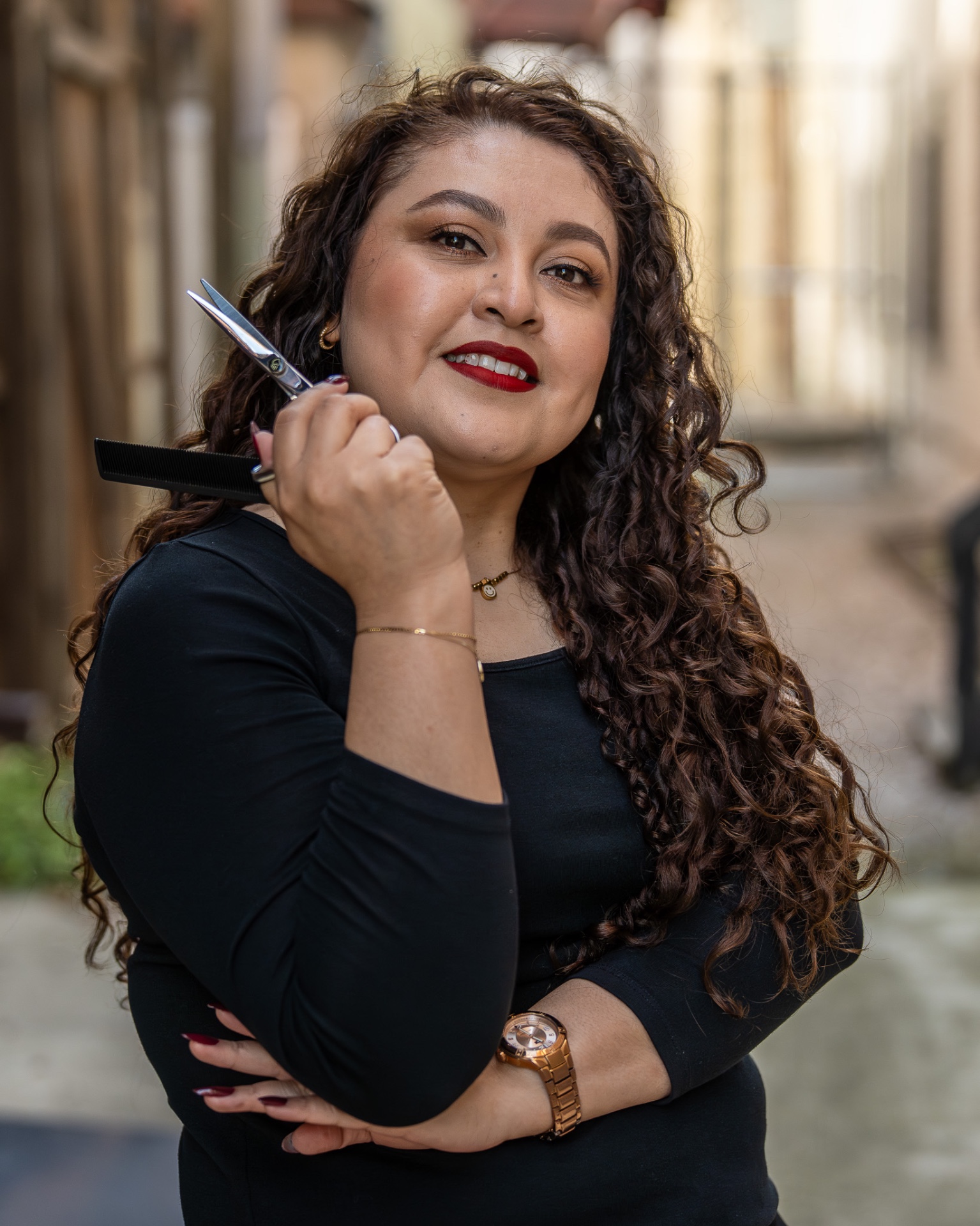 Emelia Cruz-Avila with curly hair and red lipstick in the salon
